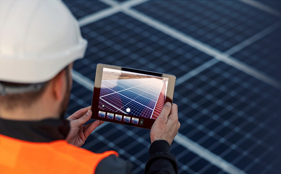 solar worker documenting panel maintenance on tablet