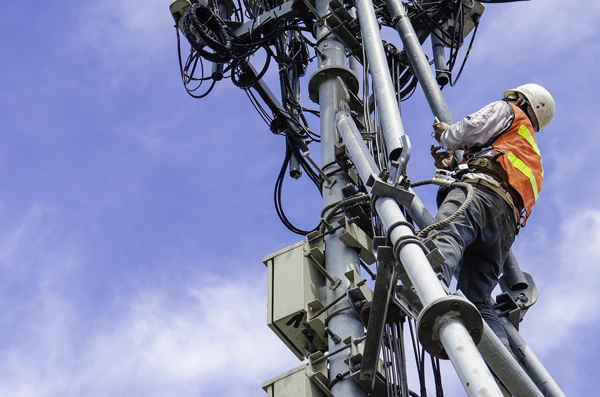 Telecom tower field worker using digital work instructions on smartphone